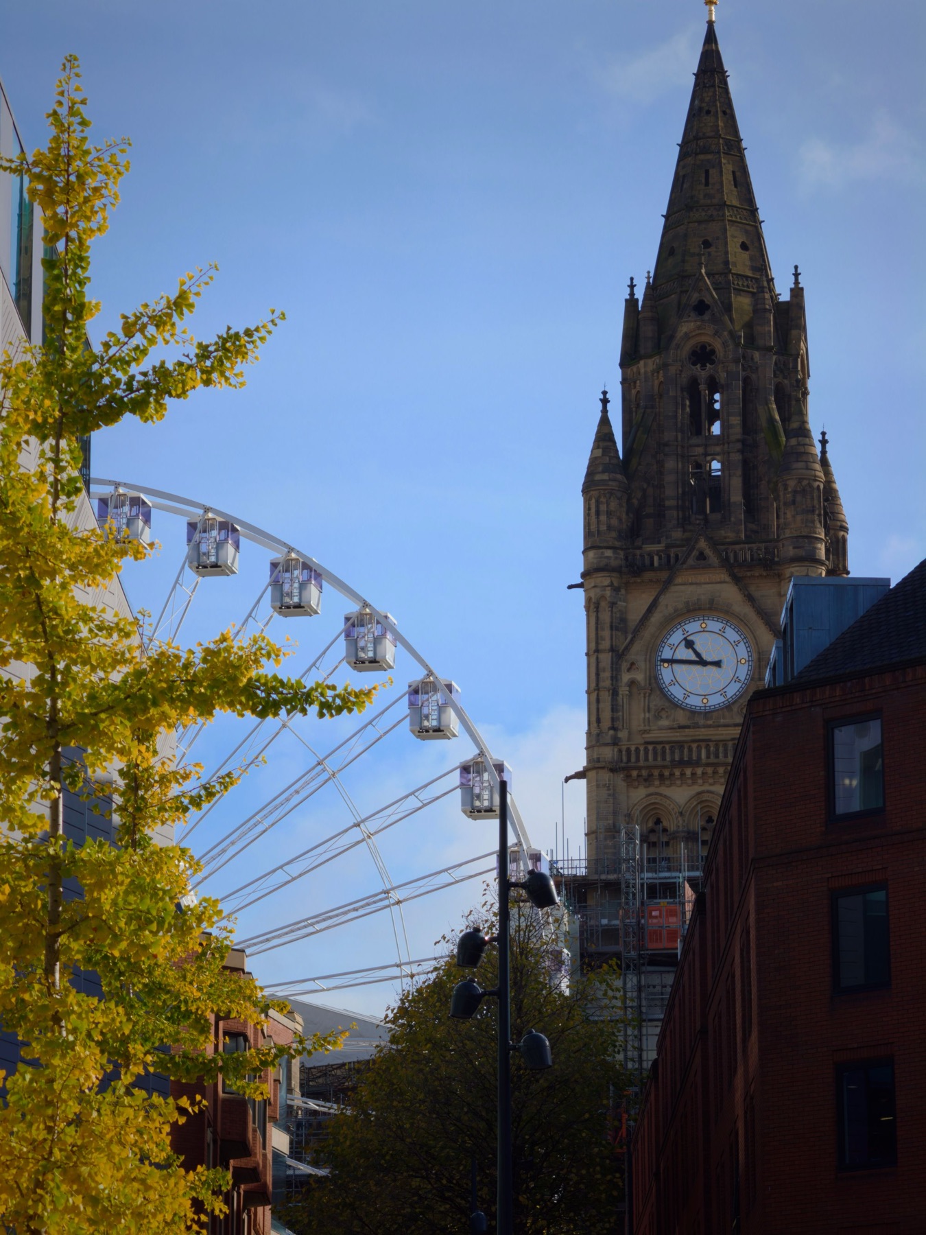 Manchester Town Hall’s clock tower beside the big wheel in autumn