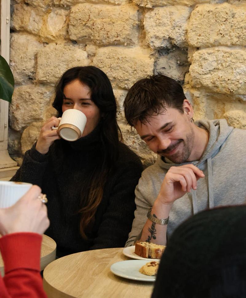 Two people sharing a laugh over coffee at a Timeleft meetup